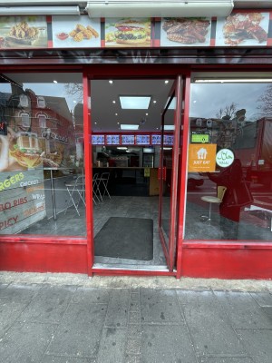 Red metal-framed glass door. Push from handle on left to open.