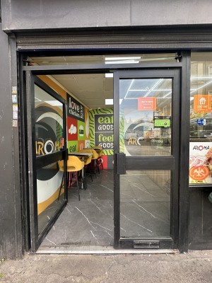 Glass doors with black frame. Push black handles in centre to open.