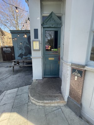 From street facing venue. Step up ahead. Door after step. Doorbell on right wall.