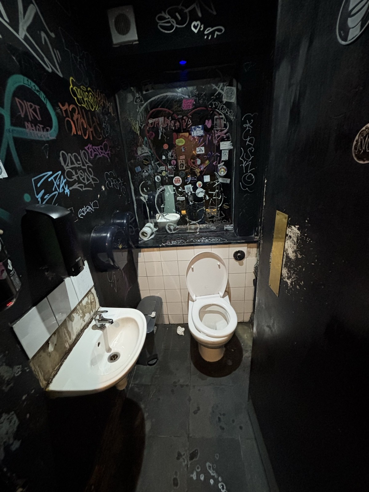 From bathroom door facing straight. Sink on left. Toilet on back.