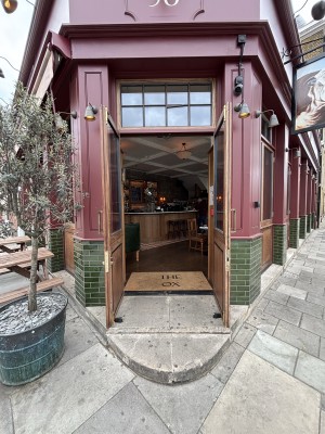 Glass doors with wooden frame ahead. Pull doors to open via handles in center.