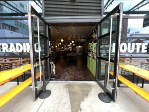 Black and glass panelled doors. Pull metal handle in middle to open.