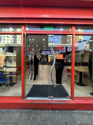 Glass doors with red frame. Push silver handles in centre to open.
