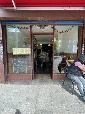 Brown metal-framed glass door. Push from handle on right to open.