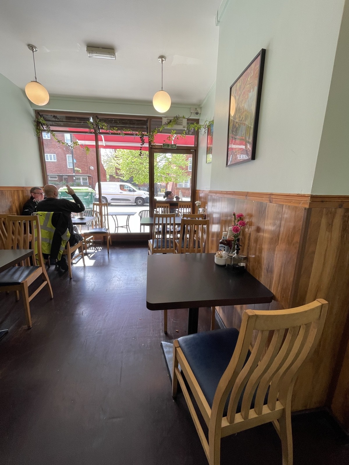 From opening facing right. Tables and chairs on left and right.