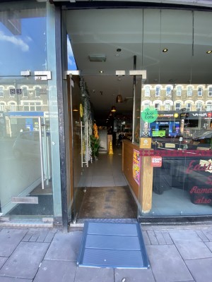Glass door ahead. Pull from metal handle on right.