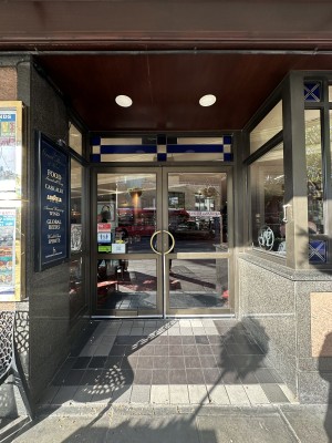 Glass doors with grey frame. Pull gold handles in centre to open.