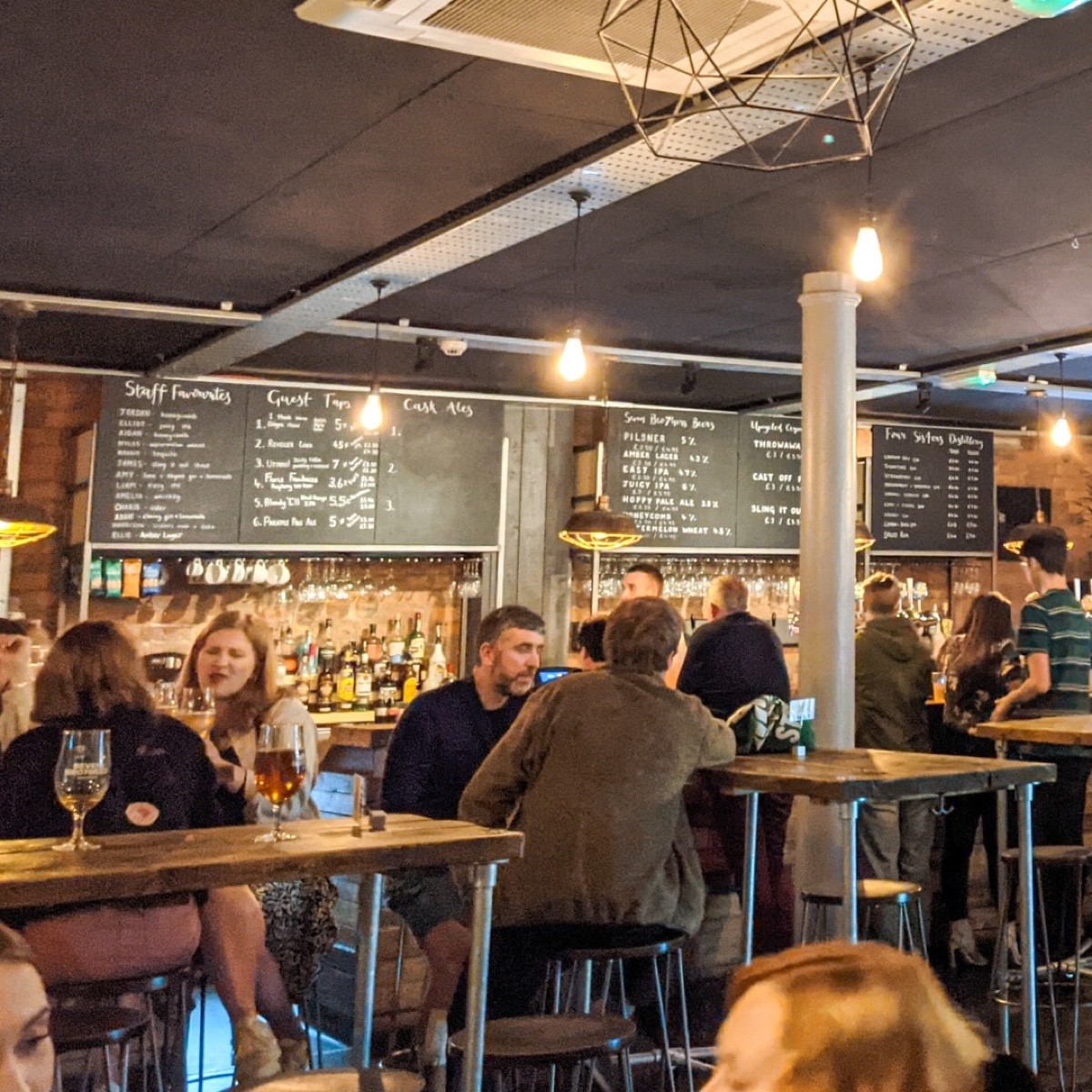 Photo shows the high tables and stools at the bar. There are also low tables with regular seats upstairs.