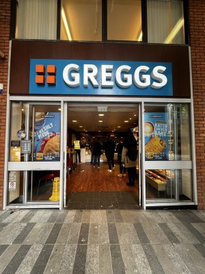 Glass doors. Slide doors outwards from handles in centre. Doors kept open during opening hours.
