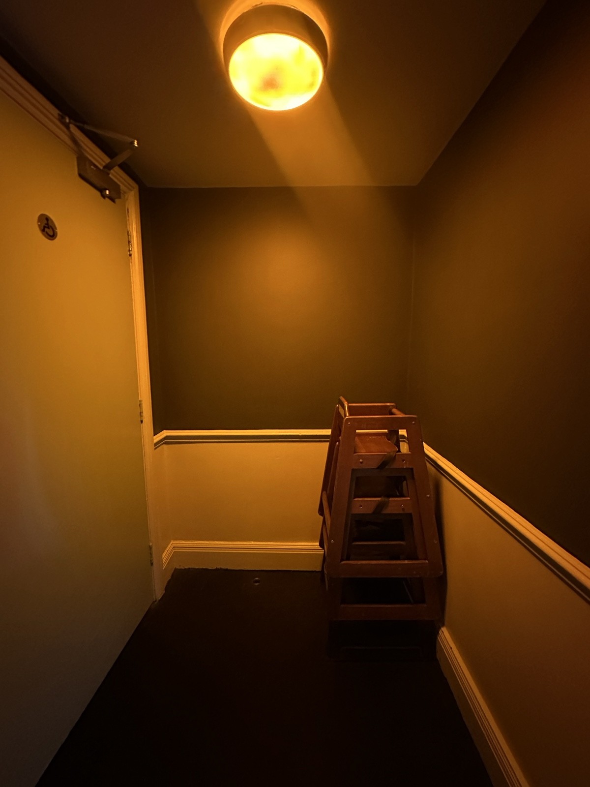 From after archway facing right. Accessible bathroom to left. Baby chairs to right.