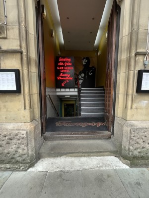 Wooden double doors ahead. Push from centre to open.