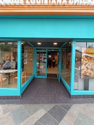 From street, facing venue. Opening ahead to doorway.