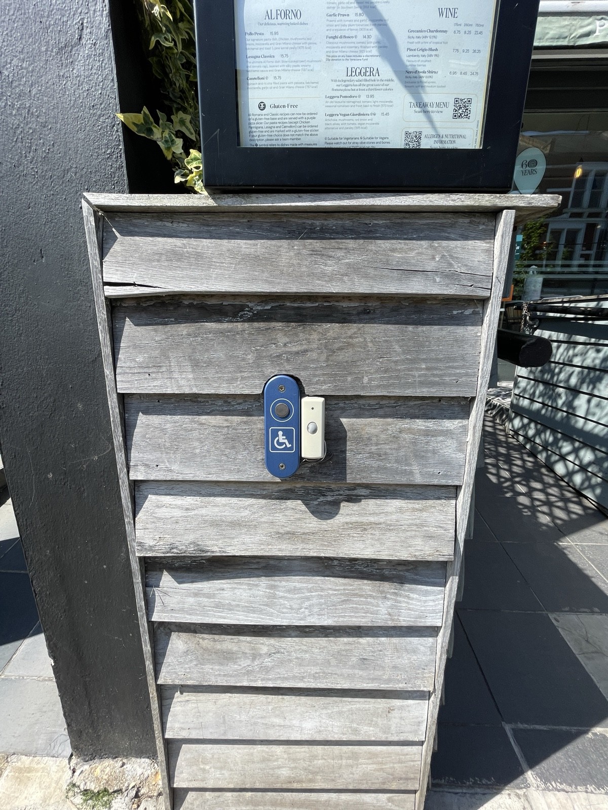 Assistance doorbell on left of door.