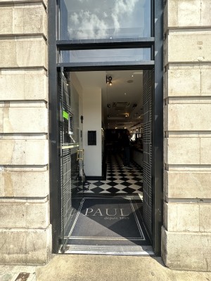 Glass door with black frame. Push gold handle from right to open.