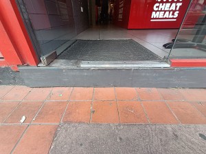 Step up before doorway, doormat after.