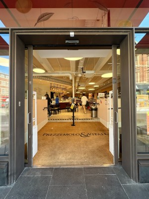 Glass doors with grey frame. Slide silver handles in centre outwards to open.