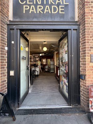 Glass doors with black frame. Push silver handles in centre to open. Door push button to right.
