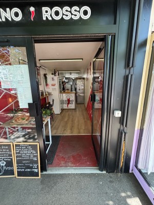 Glass door with black frames. Push from left to open.