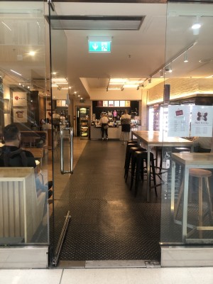 Glass door, push handle on right to open.