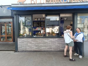 From street, facing venue. Ordering counter at back left. Service counter at back right.