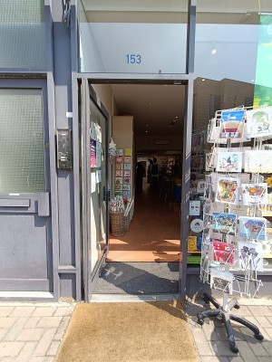 Glass door with grey metal frame ahead. Push from right to open.