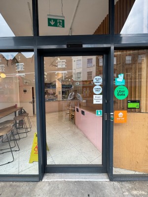 Glass door ahead. Press button on right to open.