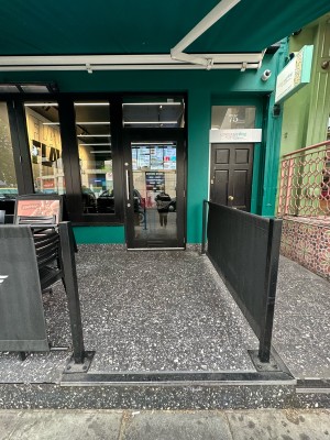 Opening ahead. Restaurant barriers to left and right.