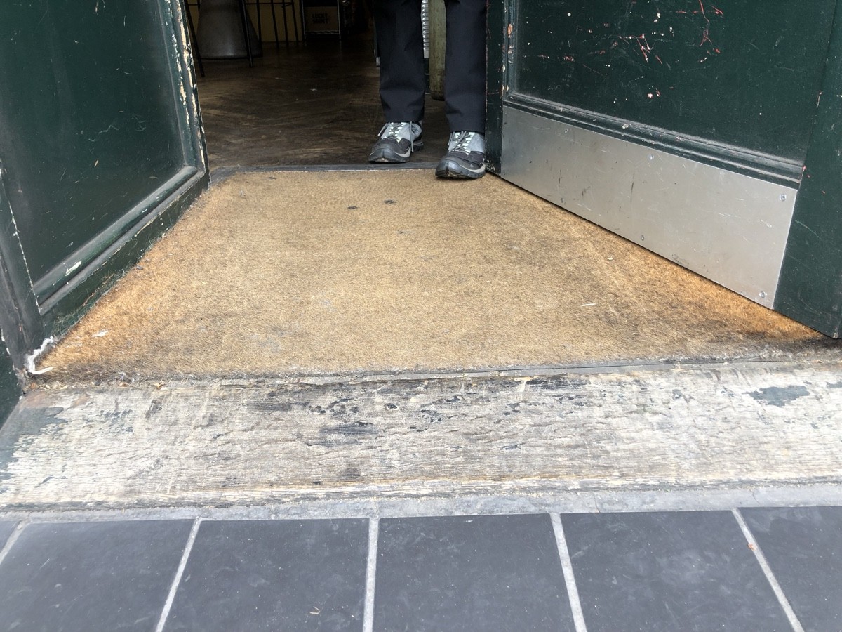 Small bump followed by doormat at foot of entrance.