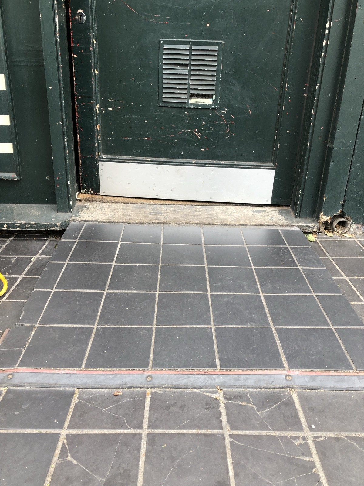 Ramp sloping upwards to entrance.
