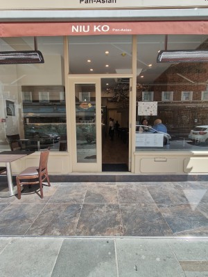 One very small step up to white framed glass doors at back. Push from centre to open.