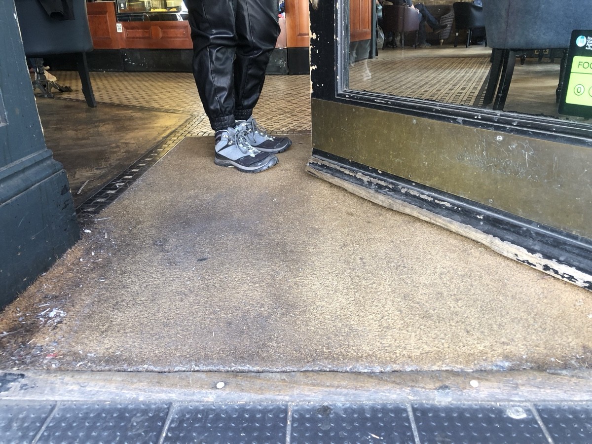 Small bump followed by doormat at foot of entrance.