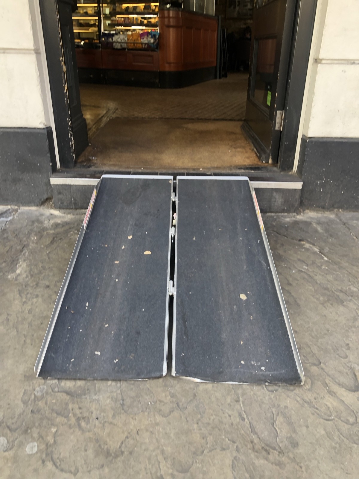 Ramp sloping upwards to entrance.