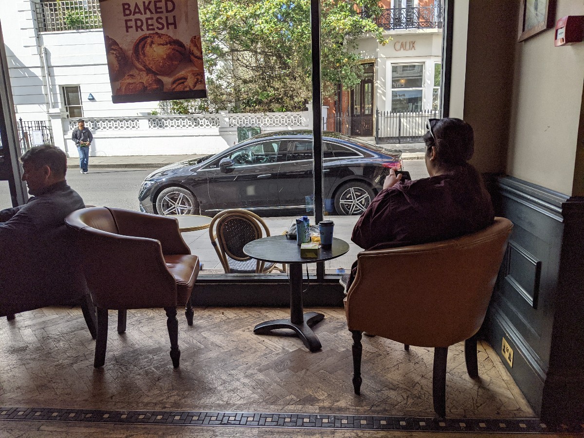 From after opening facing right. Low table with chairs ahead.