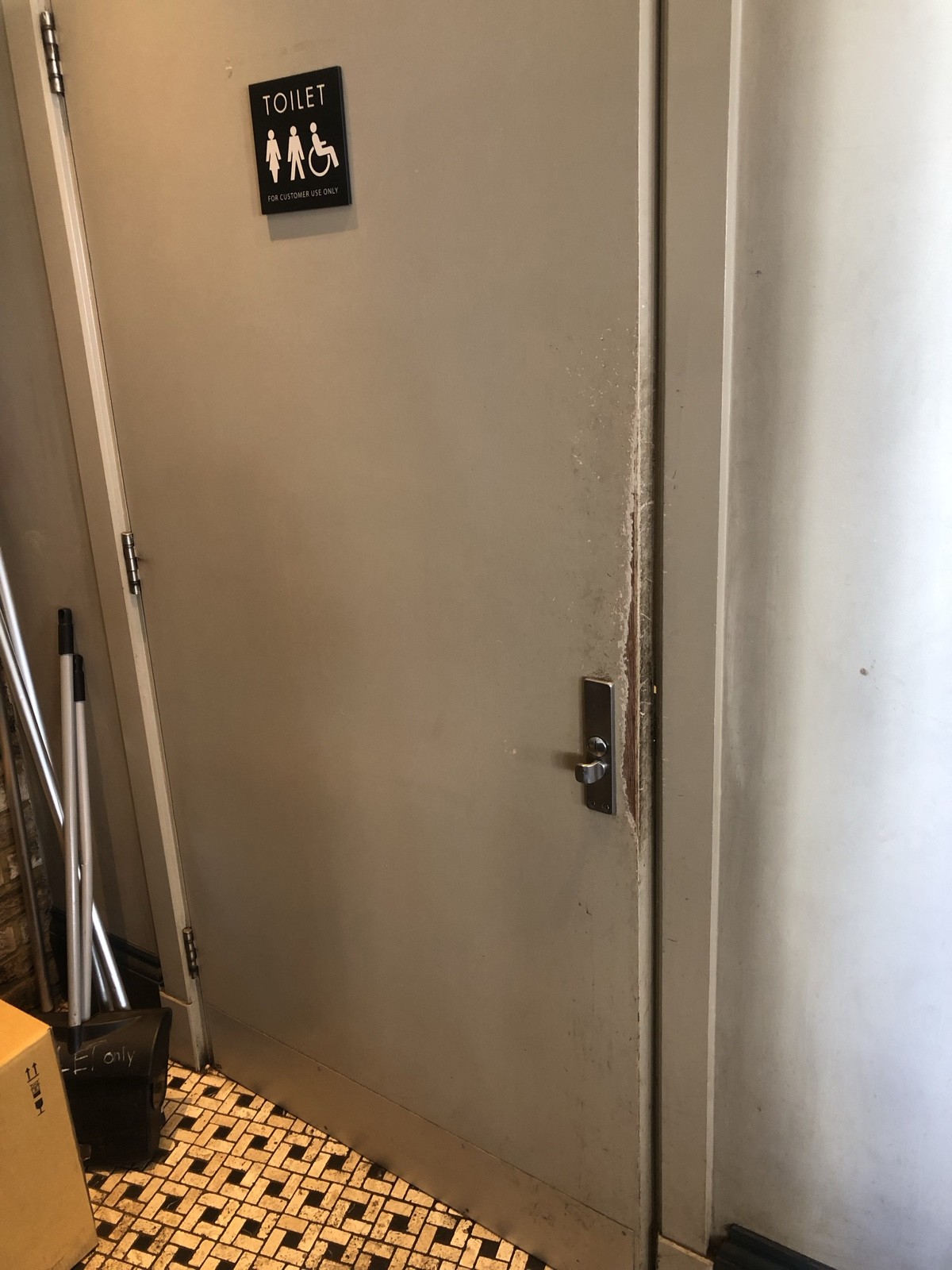 From end of pathway facing right. Bathroom door ahead. Dark grey door, pull handle on right to open.