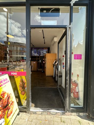 Glass door with grey frame. Push grey handle from left to open.