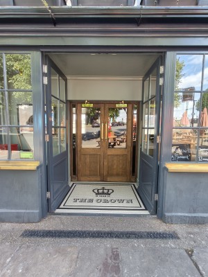 Grey framed glass preceding doors. Push from centre to open.