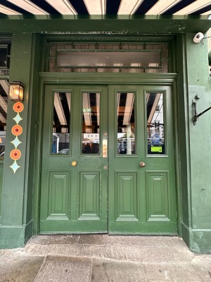 Green and glass panelled doors. Push from centre to open.