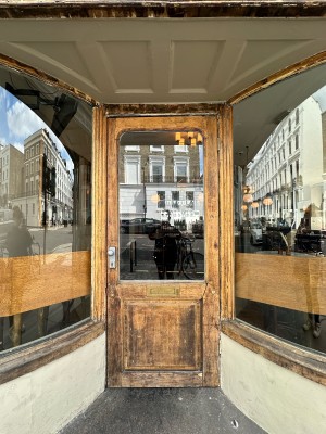 Wood and glass panelled door. Pull silver handle from left to open.