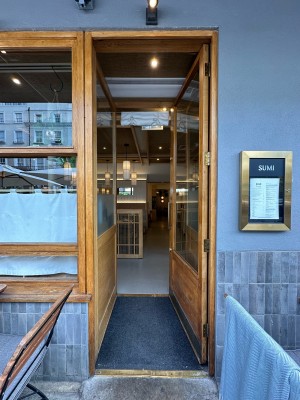 Wood and glass panelled door. Push gold handle from left to open.
