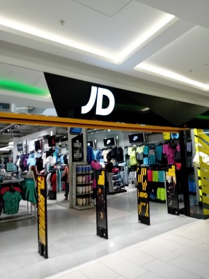 This is the enterance to the JD shop it is a large open doorway with flat flooring and plenty of room to move around the shop.