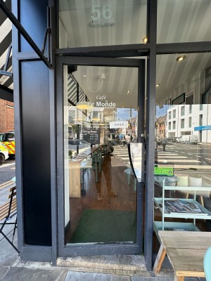 Glass door with grey frame. Push silver handle from right to open.