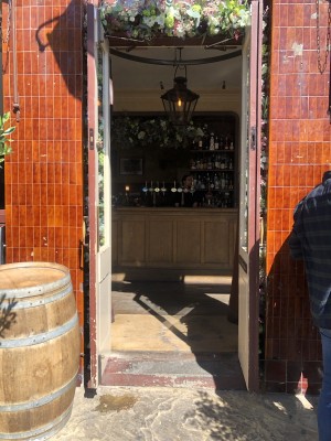 Glass doors with dark red frame. Pull golden handles in centre to open.