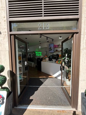 Glass doors with black frame ahead. Push black metal handles from centre to open.