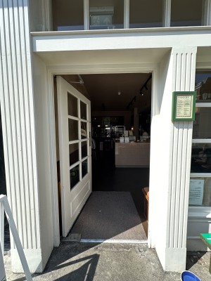 White and glass panelled door. Push from right to open.