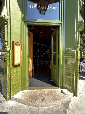 Green and glass panelled door. Push from left to open.