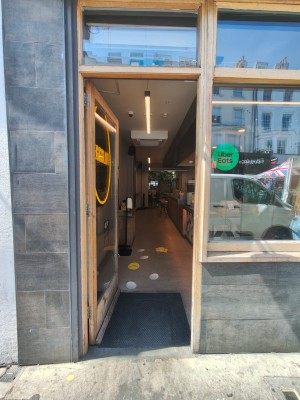 Glass door with wooden frame ahead. Push from right to open