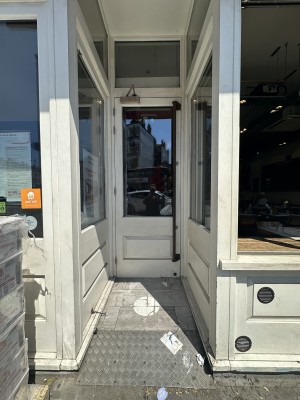 Opening followed by white and glass panelled door. Pull black handle from right to open.