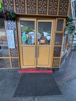 Yellow doors wjth glass panels. Push via handles in center to open.