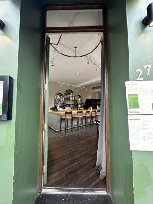 Glass door with wooden frame. Push silver handle from right to open.