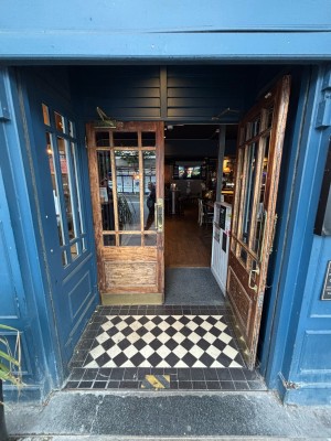 Glass doors with brown wooden frames. Pull from centre handles to open.